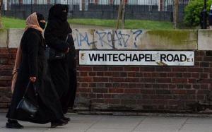 Muslim women walk along London's Whitechapel Road.