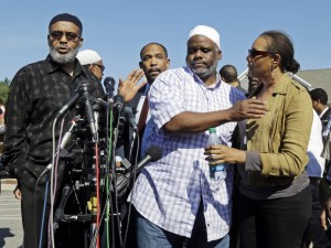 Ibrahim Rahim, second from right, brother of shooting victim Usaama Rahim, reacts with a relative during a news conference Thursday, June 4, 2015, in Boston’s Roslindale neighborhood in the area where Rahim was shot to death. Police said Usaama Rahim had lunged at members of the Joint Terrorism Task Force with a knife when they approached to question him. (Elise Amendola/Associated Press)