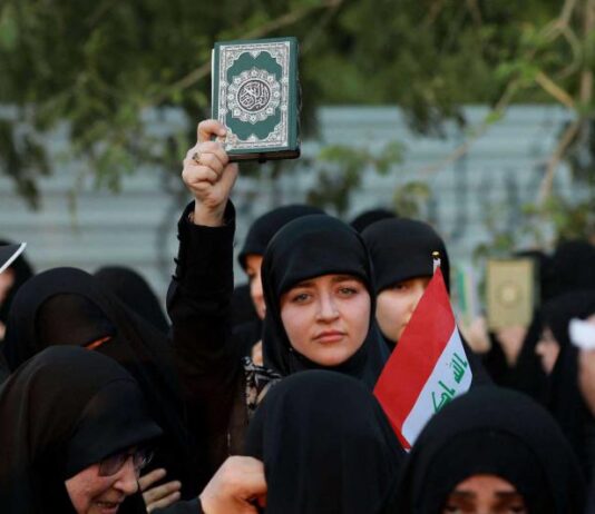 Supporters of Iraq’s Hashed al-Shaabi (Popular Mobilisation) group take part in a protest denouncing the burning in Sweden of the Quran, near Baghdad’s Green Zone. Image Courtesy: www.thearabweekly.com