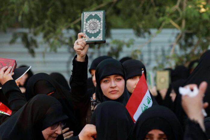 Supporters of Iraq’s Hashed al-Shaabi (Popular Mobilisation) group take part in a protest denouncing the burning in Sweden of the Quran, near Baghdad’s Green Zone. Image Courtesy: www.thearabweekly.com